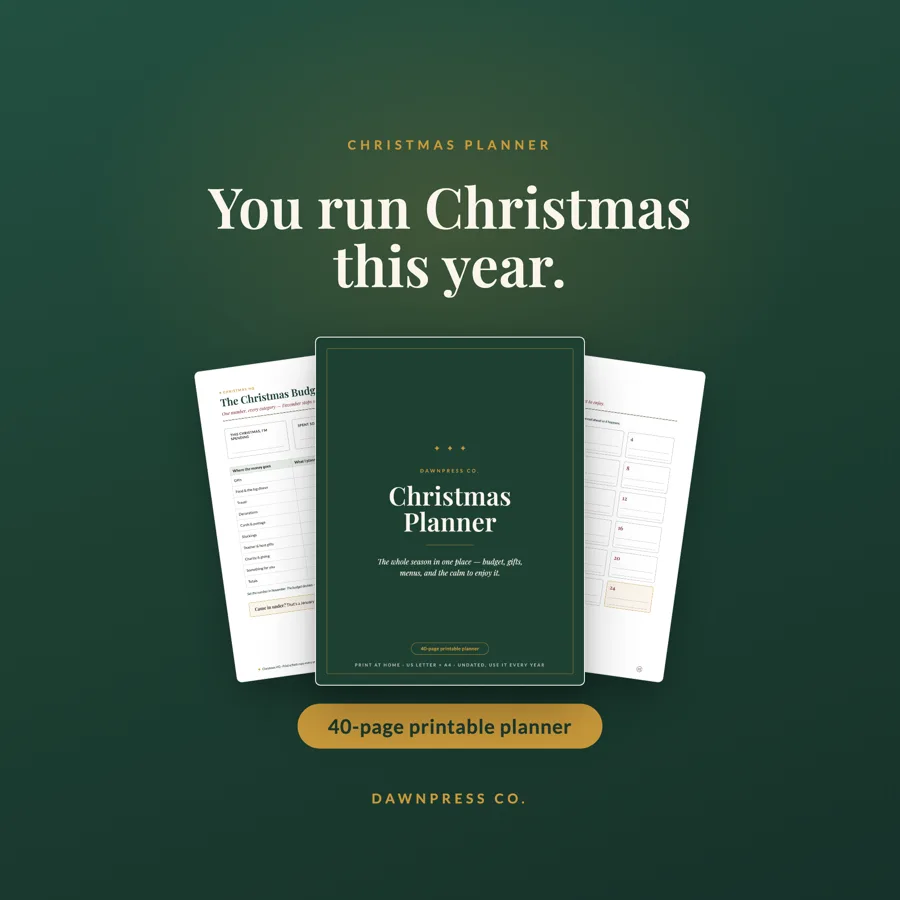 Christmas Planner cover in deep evergreen with gold serif type, fanned over budget pages